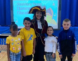  Principal Rodriguez with students during Pirate assembly